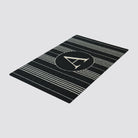 black and white basic stripe monogrammed doormat on white background