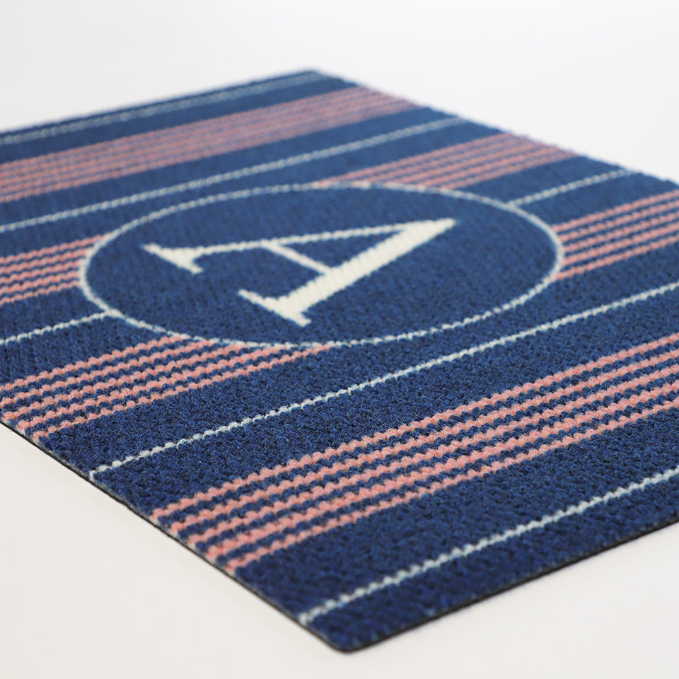 Close up of navy and pink basic stripe monogrammed doormat