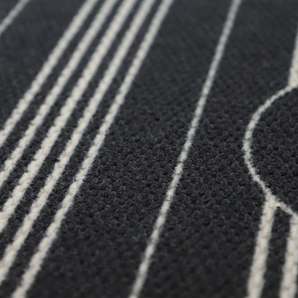 close up of basic stripe monogram doormat. thin white stripes on a black background