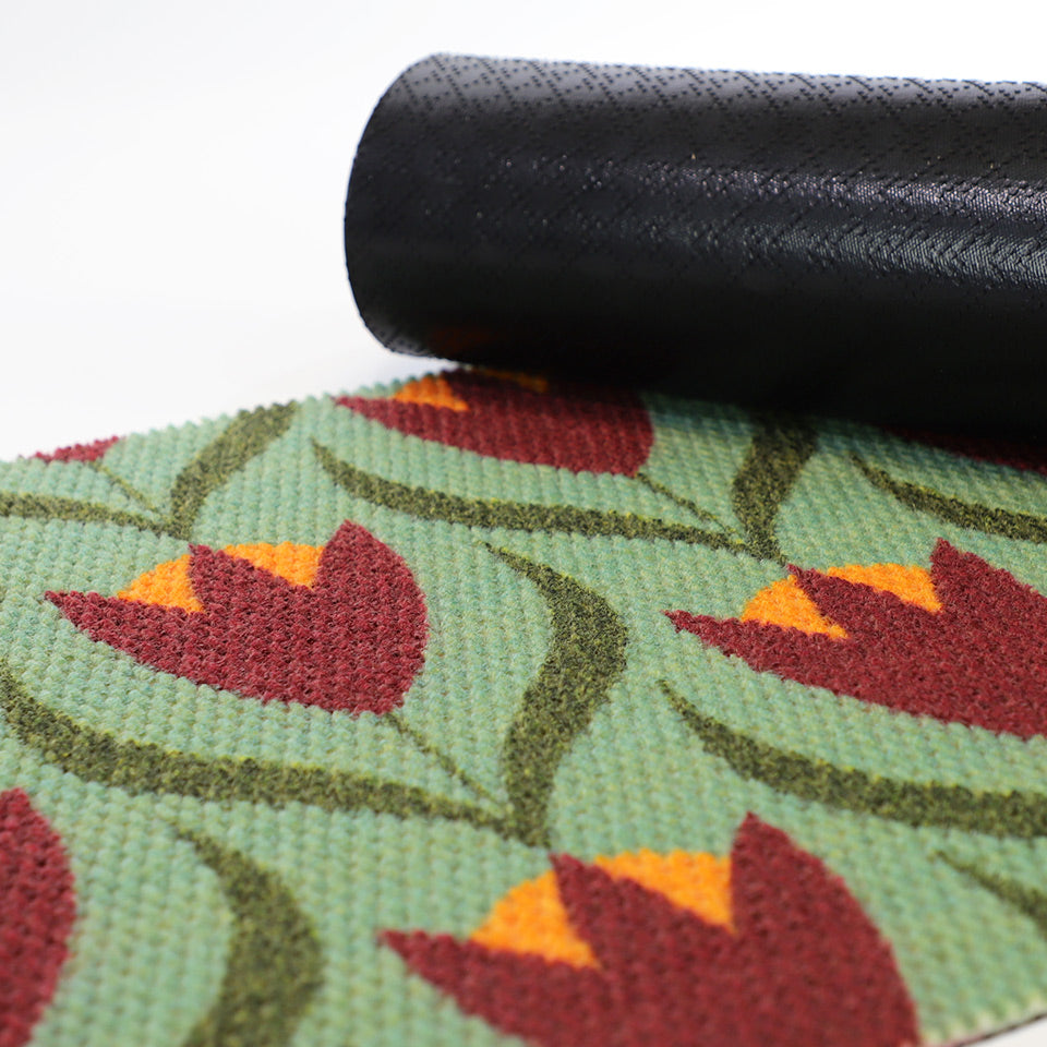 green and dark red buttercups doormat with corner rolled over to reveal black rubber cleated backing