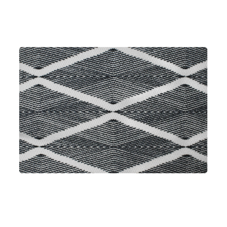 Minimalist doormat with black and white pattern excels at trapping dirt.