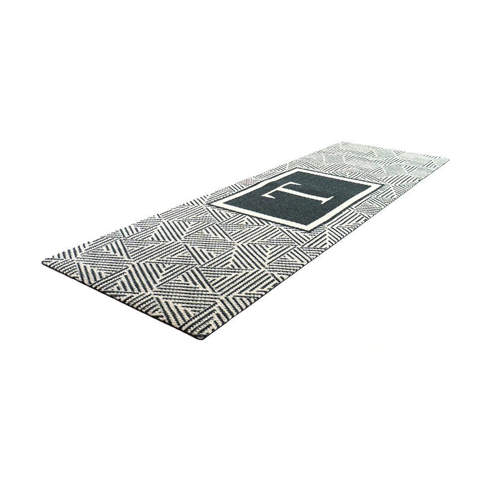 White and black wide monogrammed doormat features modern text and pattern to be placed at larger front doors and French Doors.