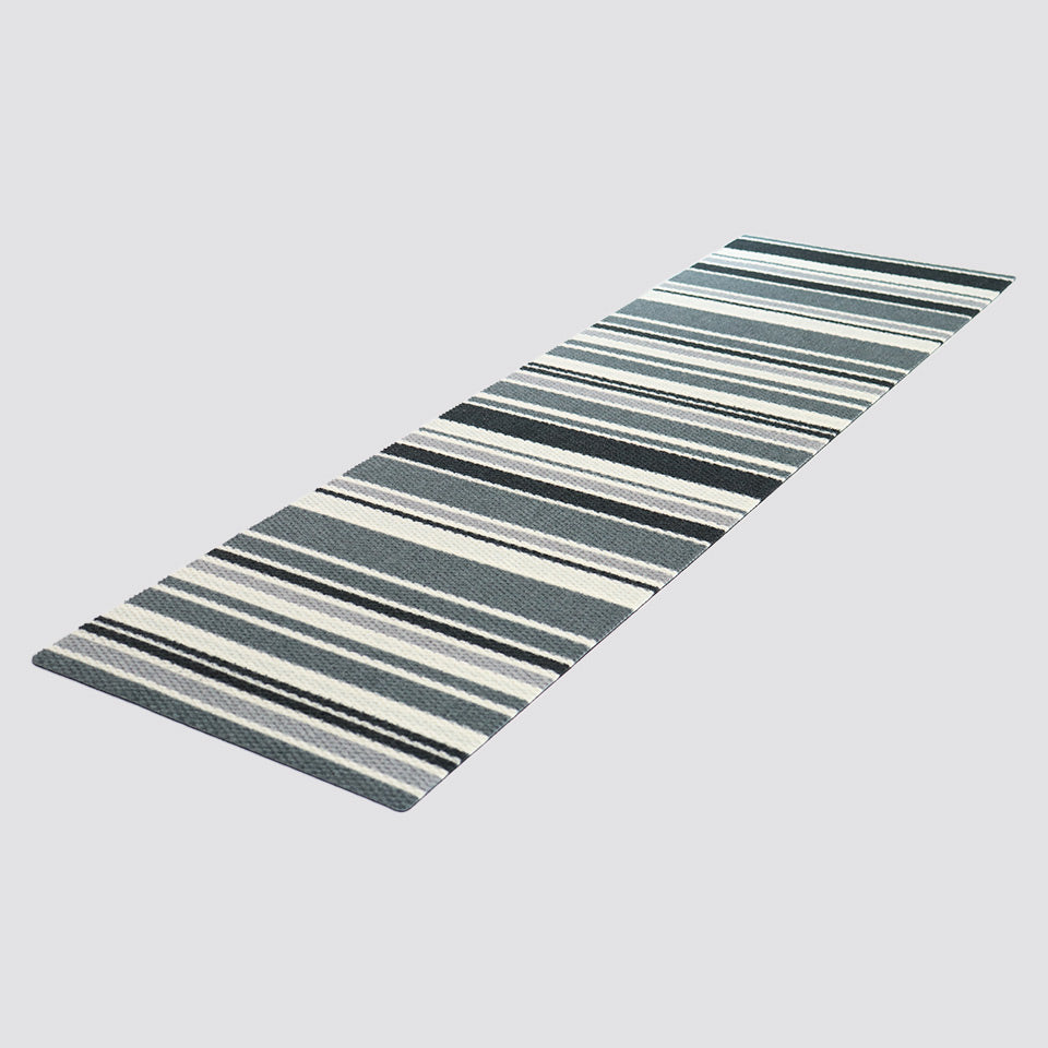 Angled shot of double door sized doormat in grey black and white stripes