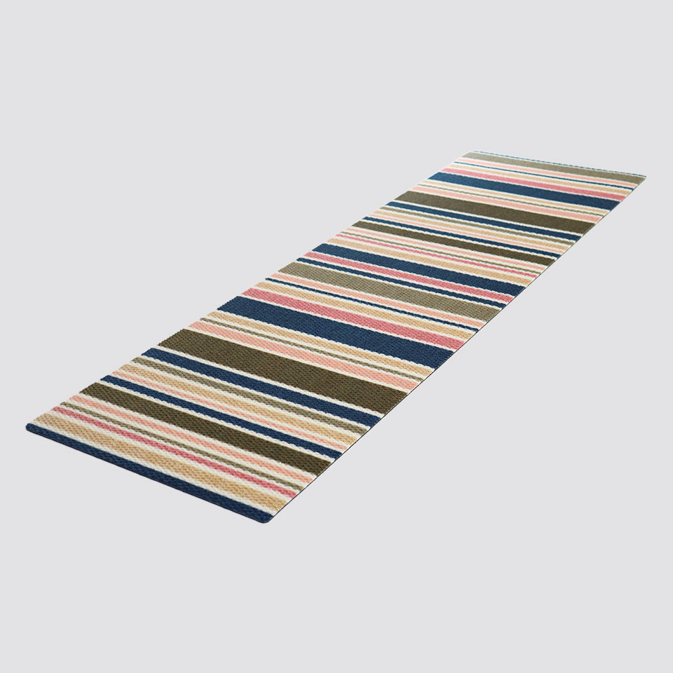 Angled shot of double door striped doormat in brown pink and navy stripes