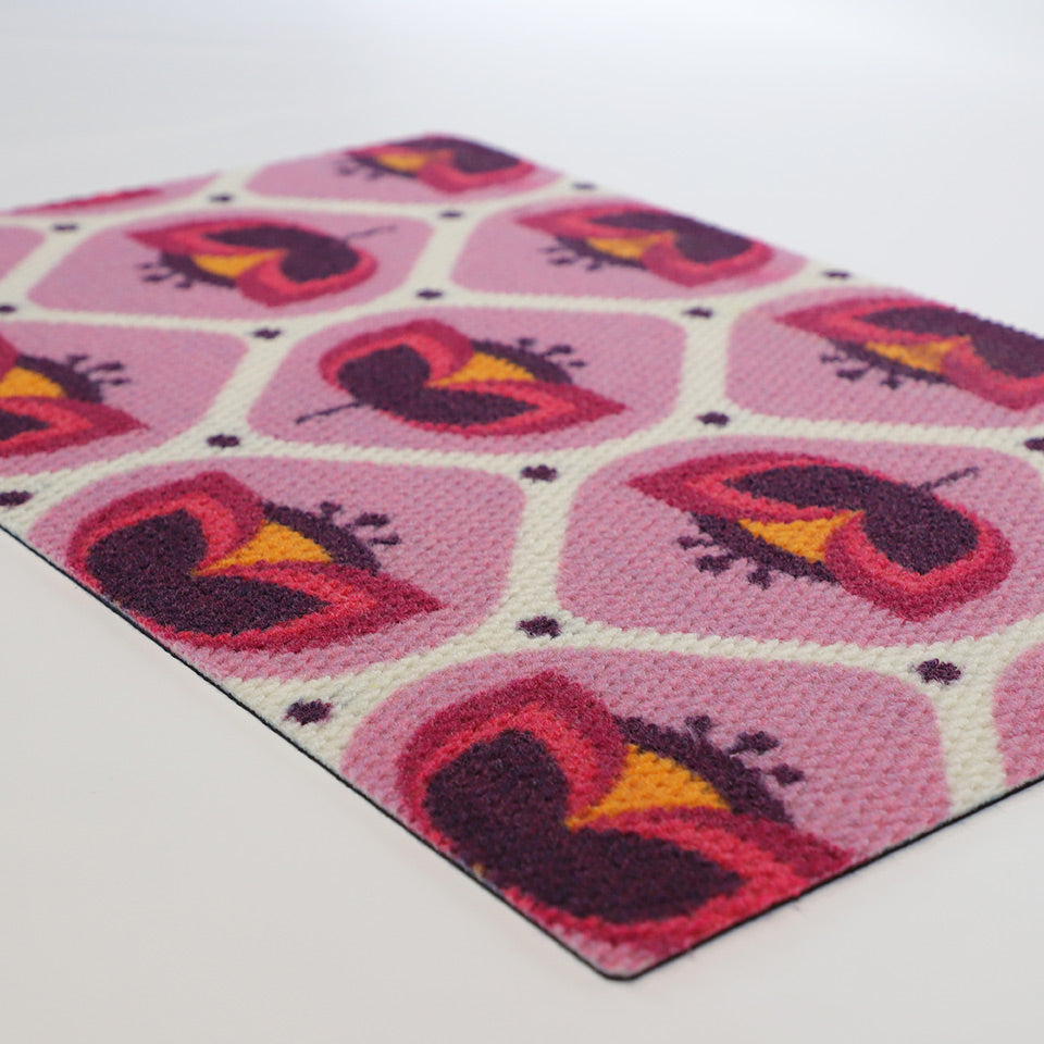 Angle shot of pink and purple retro tulip designed doormat
