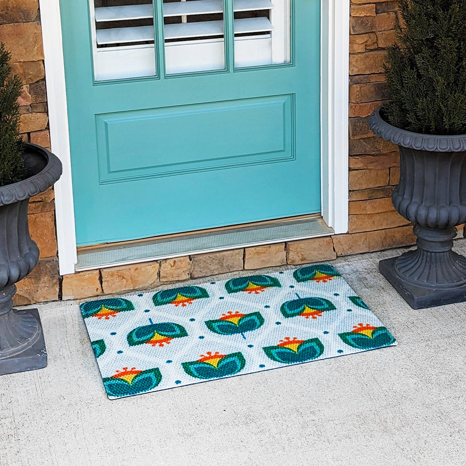 Teal and orange MCM inspired tulip design in front of aqua door on front porch