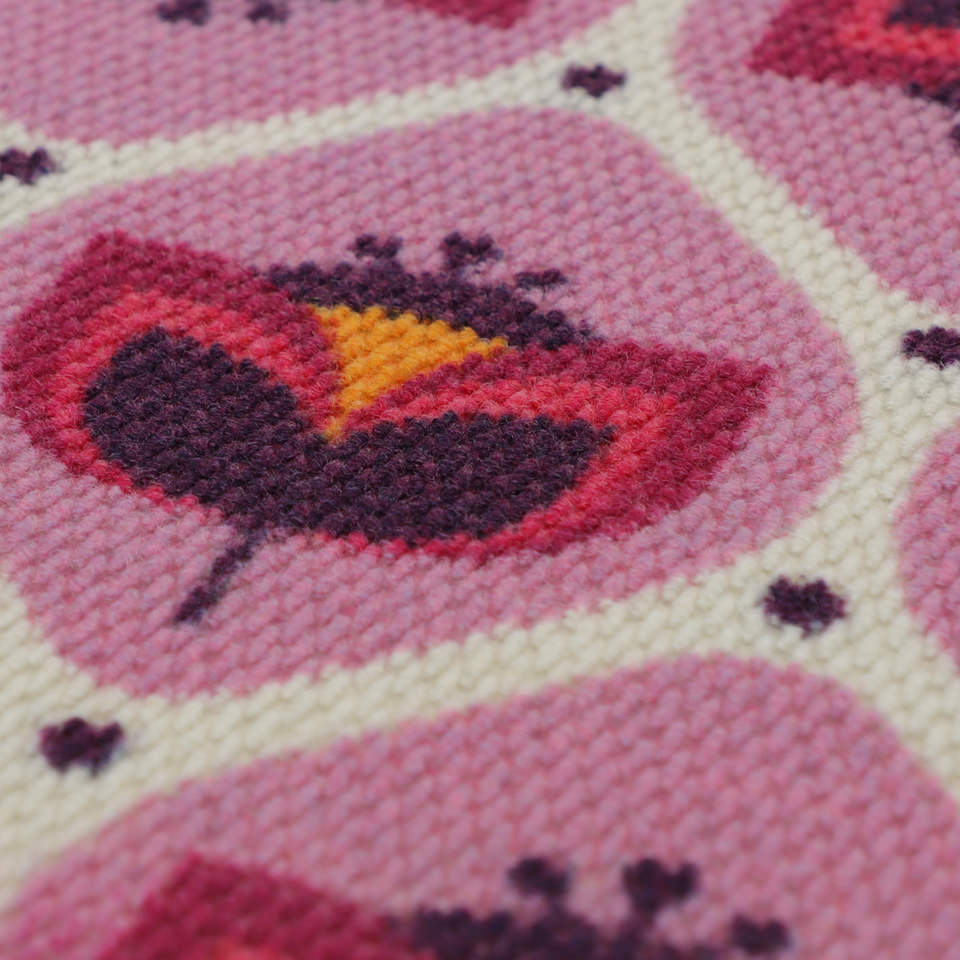 Close up of non shedding doormat in pink and purple retro tulip design