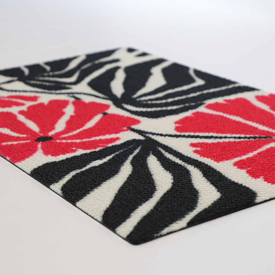 Angle shot of pink, black, and white botanical floral doormat