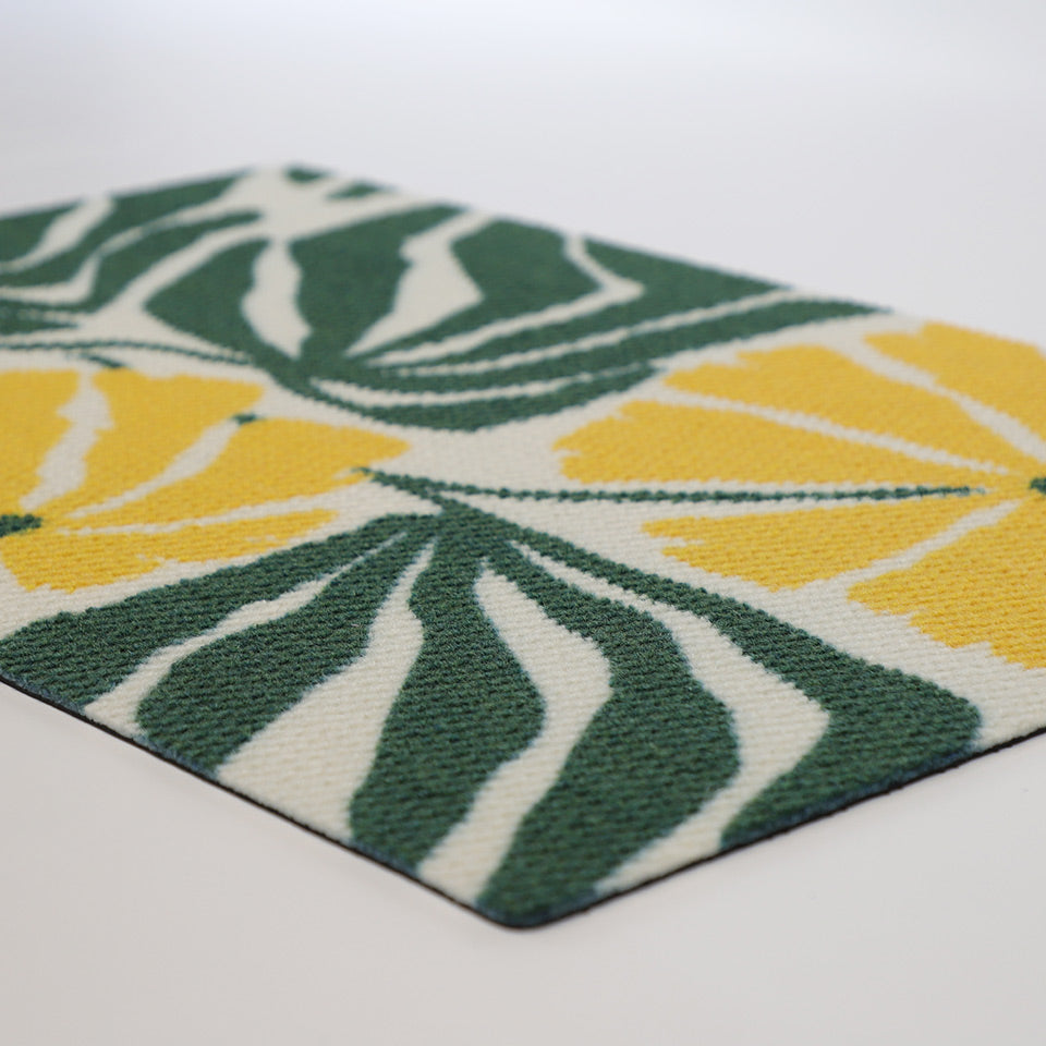 Angle shot of green and yellow botanical floral doormat design