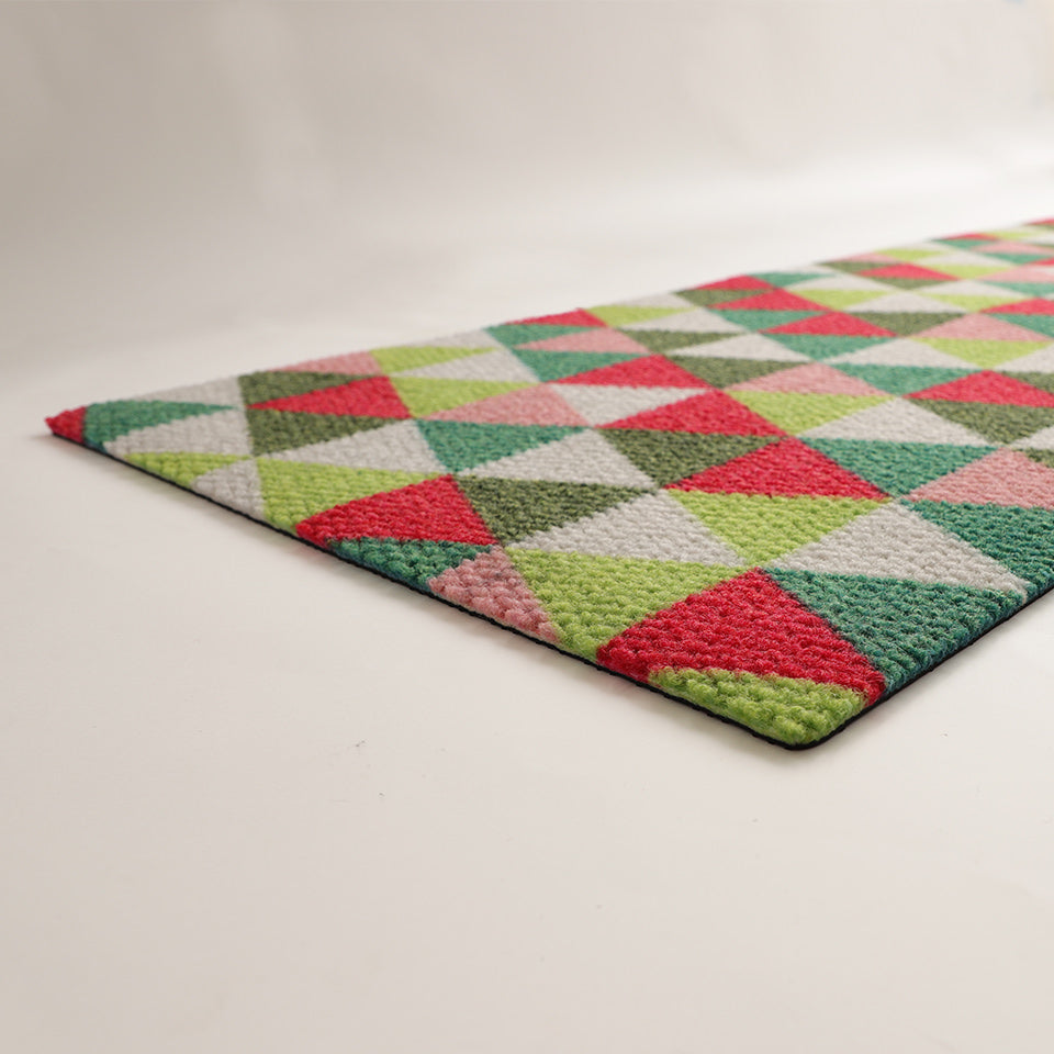 Low profile view of Christmas doormat in green red white and pink