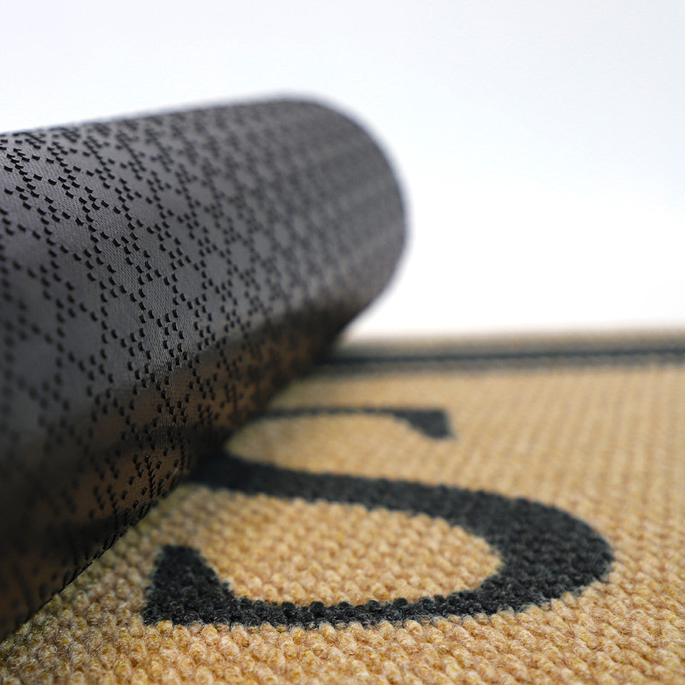 Close up of rubber backing on our monogrammed striped doormat