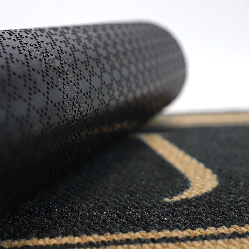 Close up of rubber backing on monogrammed black and tan doormat