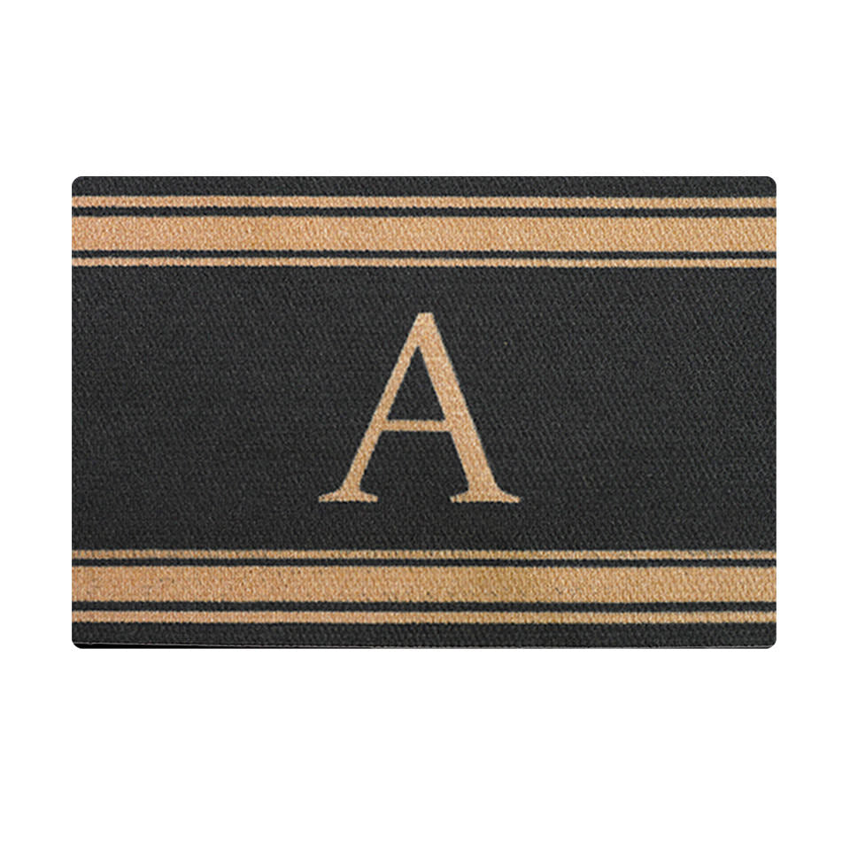 Black doormat with coir colored strips at top and bottom with coir colored monogram in center