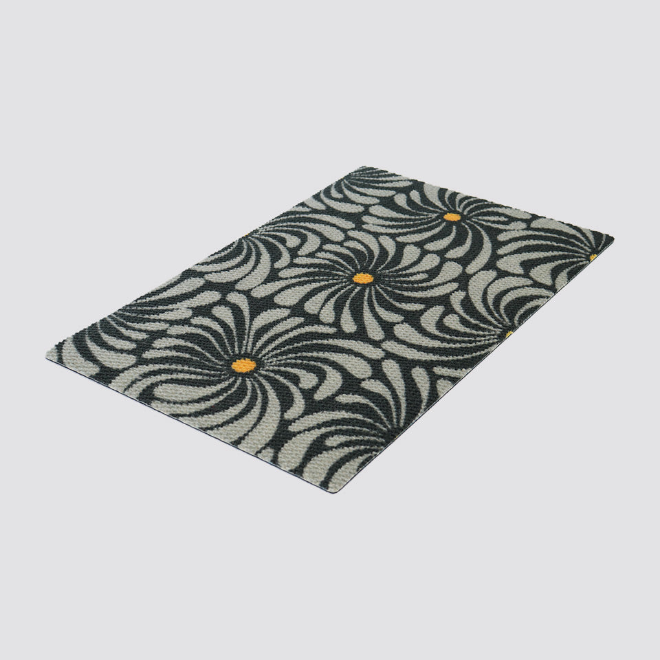 Angled shot of grey and yellow funky retro floral doormat