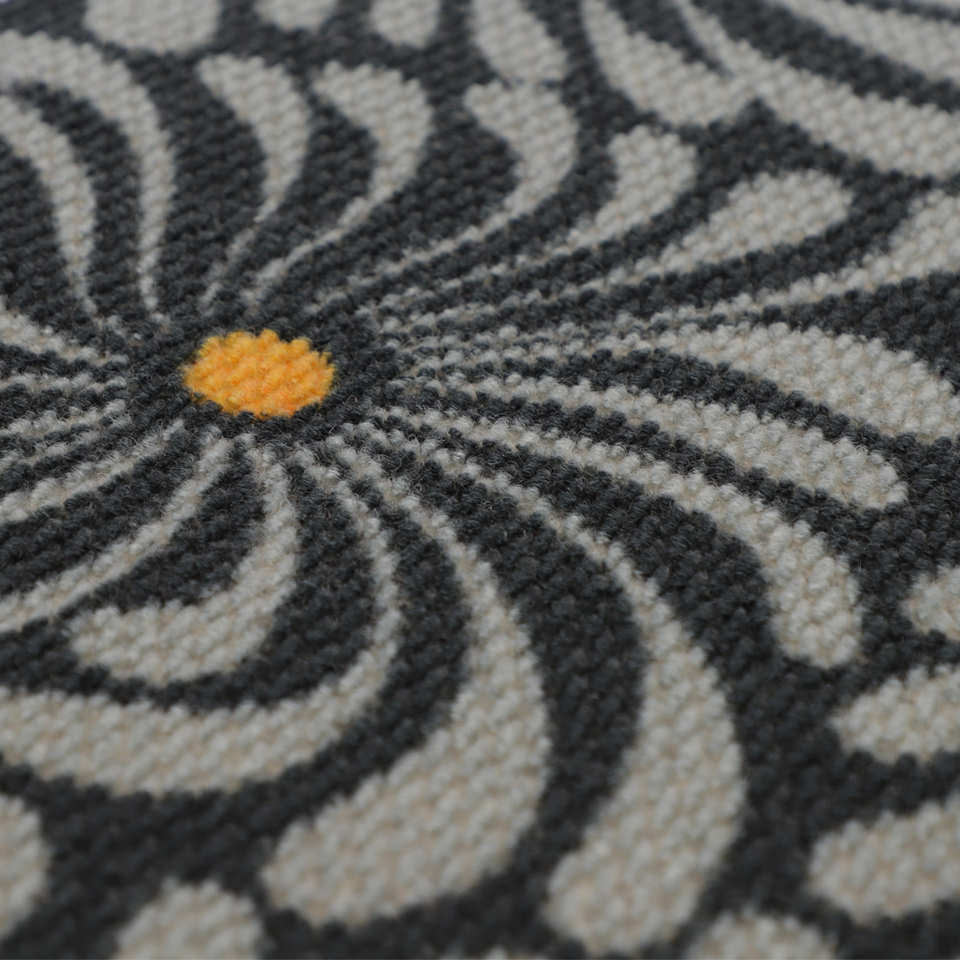 Close up of retro funky grey and yellow floral doormat