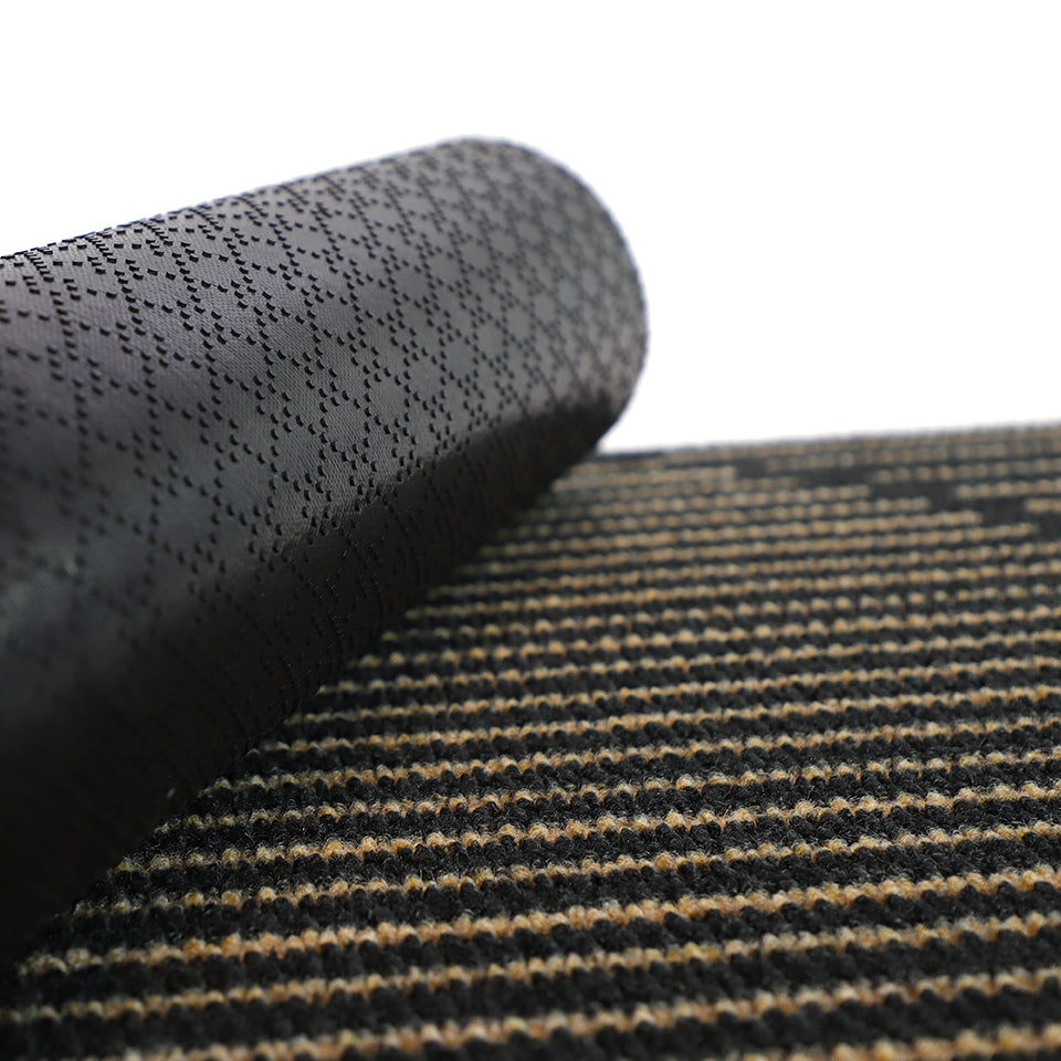 Close up of rubber backing on non shedding doormat in black and tan