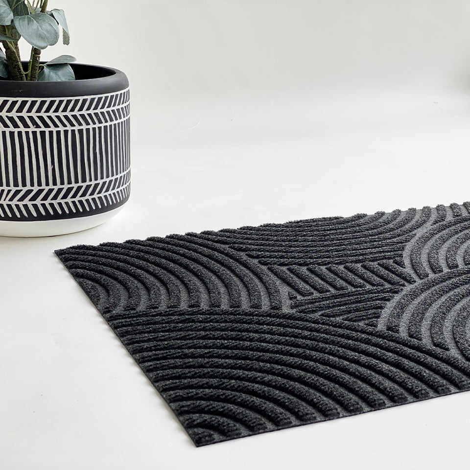 Put Your Records On single door doormat in graphite is a durable mat with a modern pattern.  An all-weather and low-profile doormat that can be used inside or outside. Made in the USA.