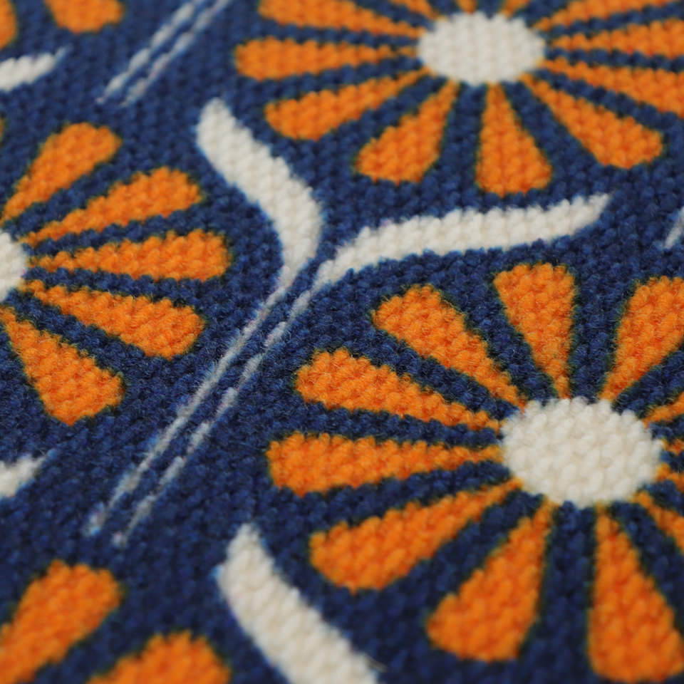 Mid century modern inspired Retro Daisies doormat in orange and blue.  A nostalgic retro nod to MCM style for our doormat collection.
