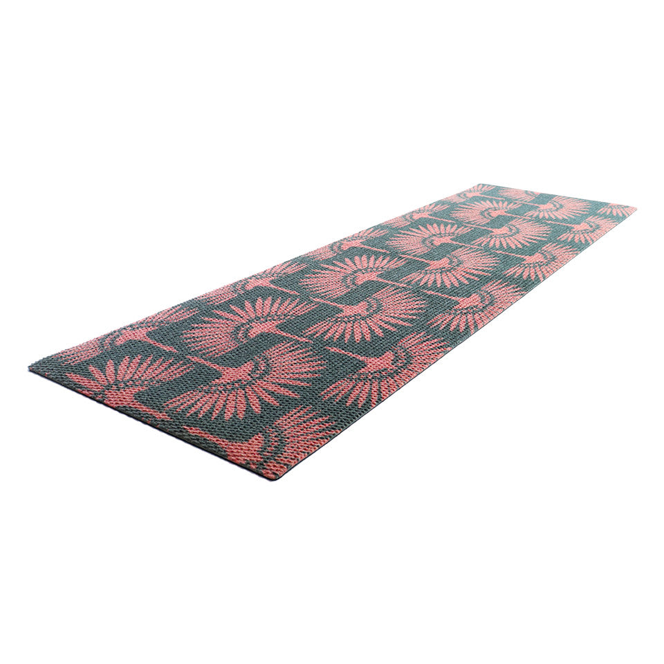 Angled shot of Tailfeathers modern crane retro inspired doormat shown in pink and dark grey.