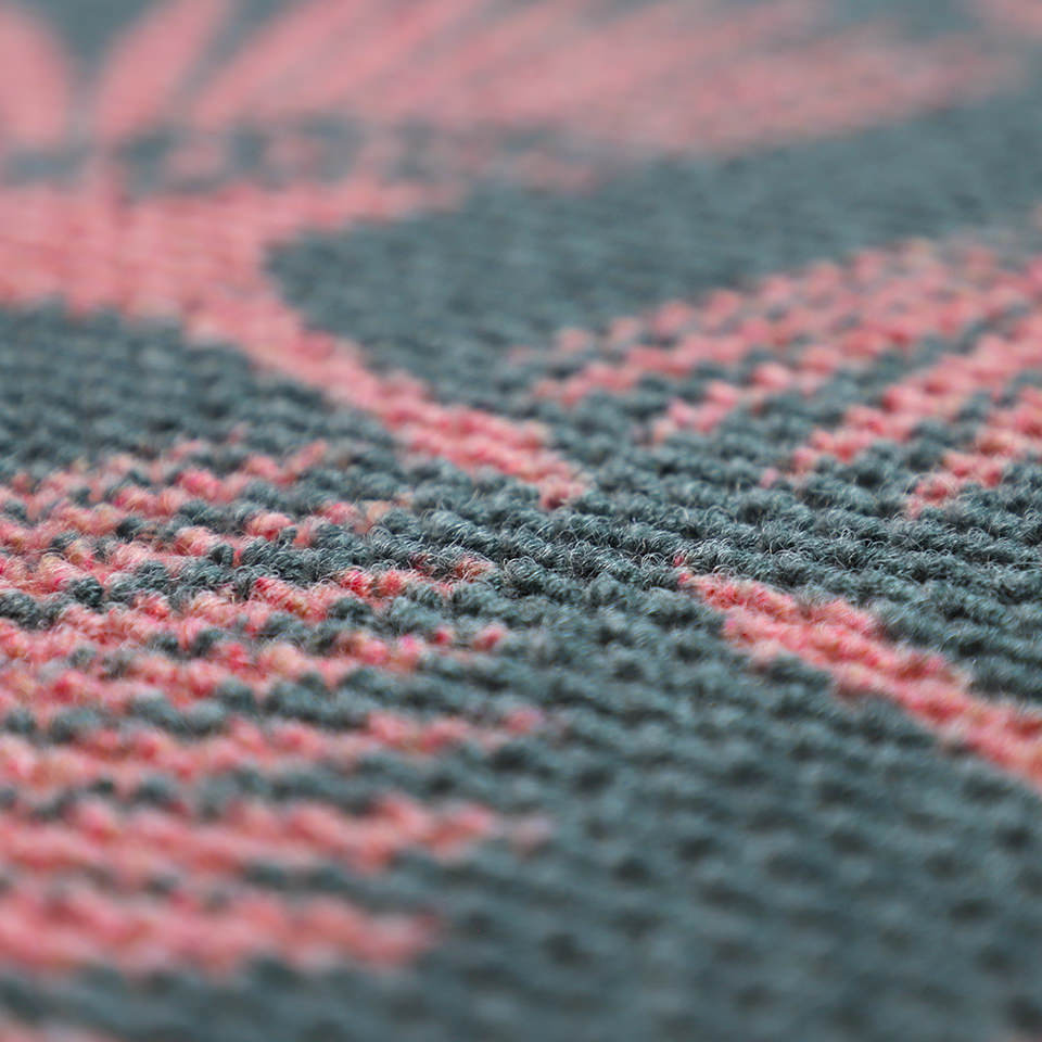 Close up of Tailfeathers doormat in pink and grey. Modern crane design for retro feel with a modern take. 