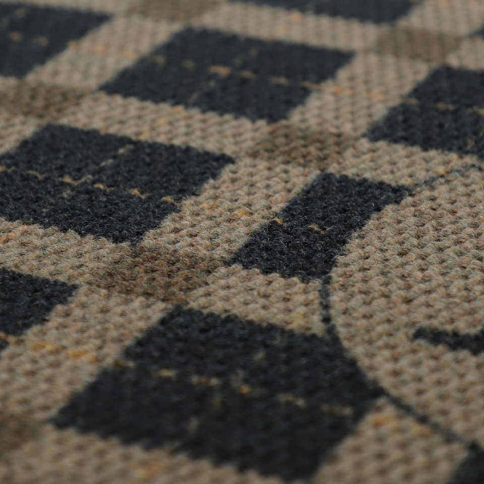 Close up of brown and black plaid non shedding doormat