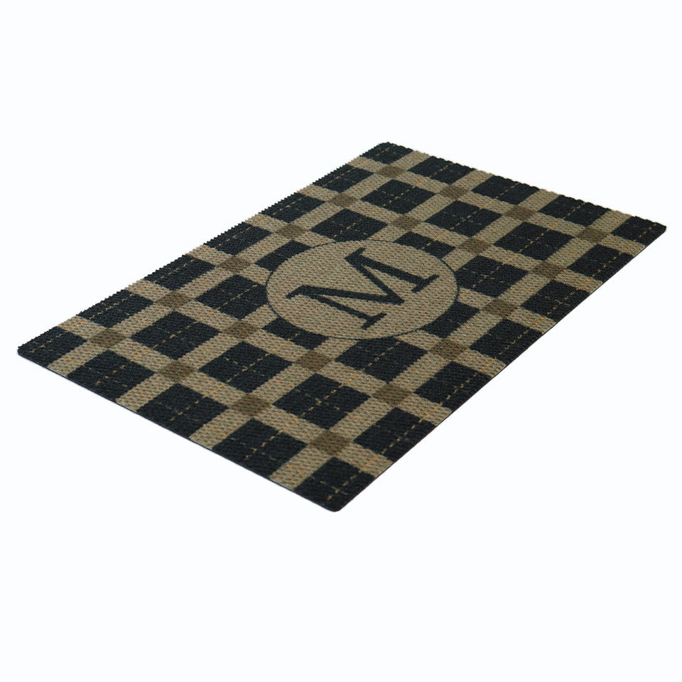 Personalized monogrammed doormat shown in black and tan for a single door