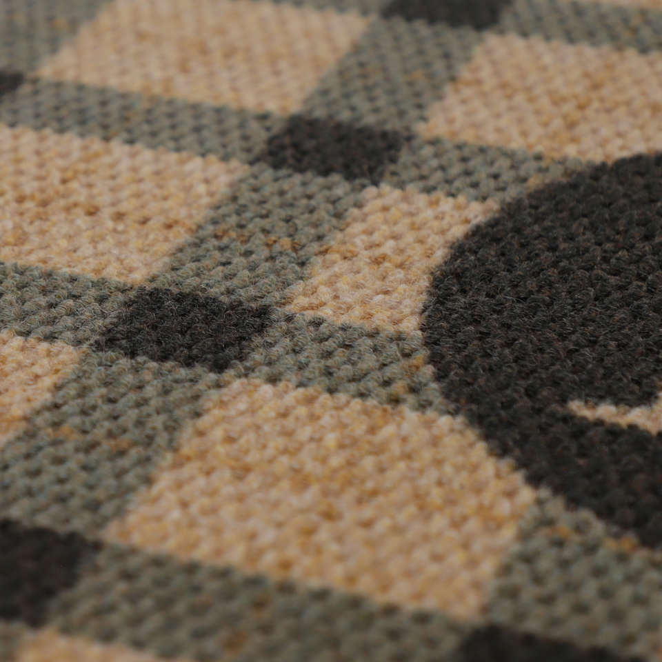 Close up of brown and black plaid monogrammed doormat