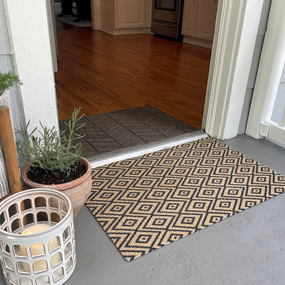single door size diamond dot coir and black mat at front entryway paired with Needle & Tread In Vein 