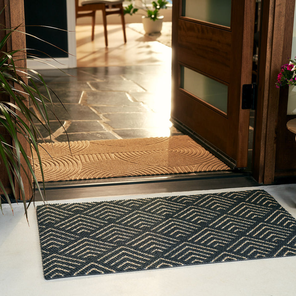 Single door size Due North doormat is a modern stylish door mat that features a black and yellow geometric pattern that looks great in front of a mid-century modern wooden door..