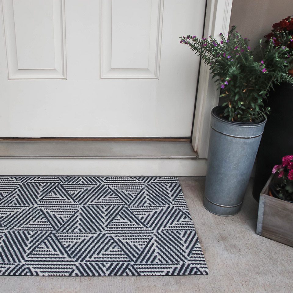 black and white escher doormat outside of front entryway