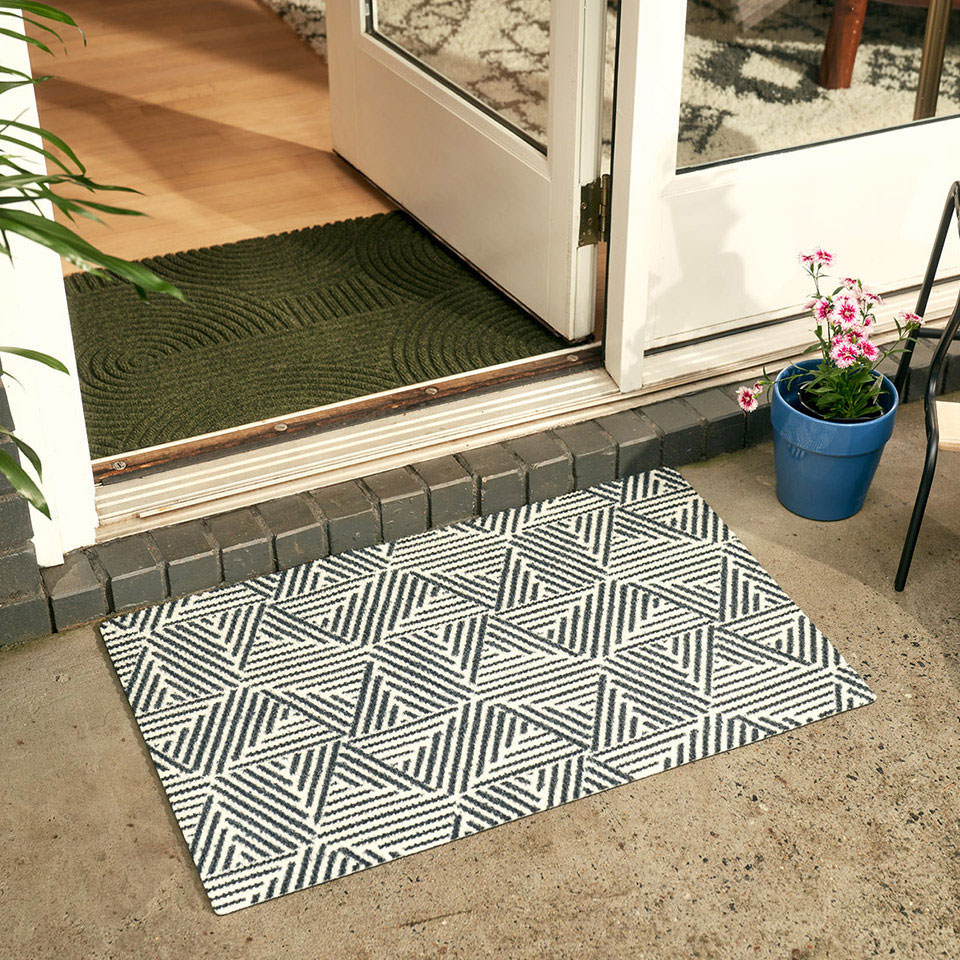 single size escher doormat in black and white outside entryway