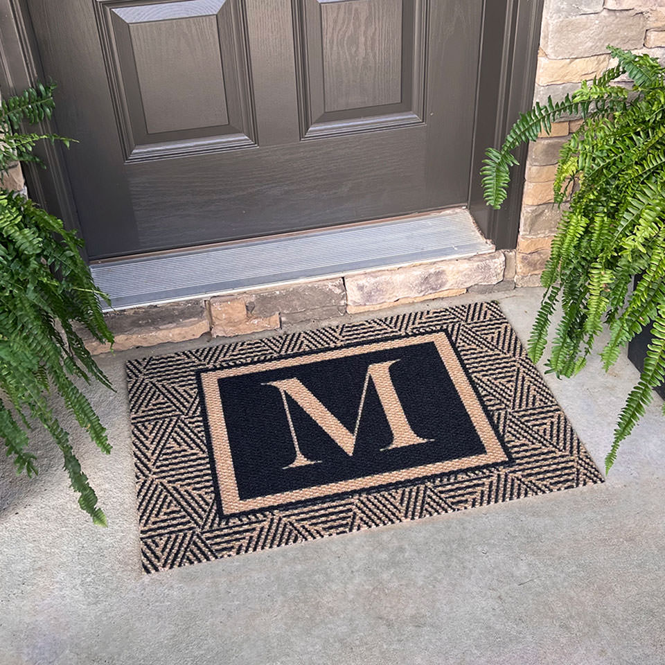 monogrammed esher doormat single size in black and coir outside of entryway