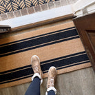 Coir tan and black striped flour sack doormat at front door