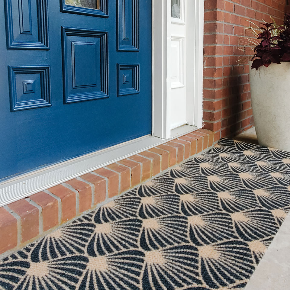 Low profile black and coir bloom floral doormat for double door