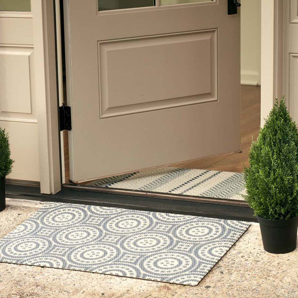 Grey and white circle medallion doormat paired with textured stripes doormat at front door