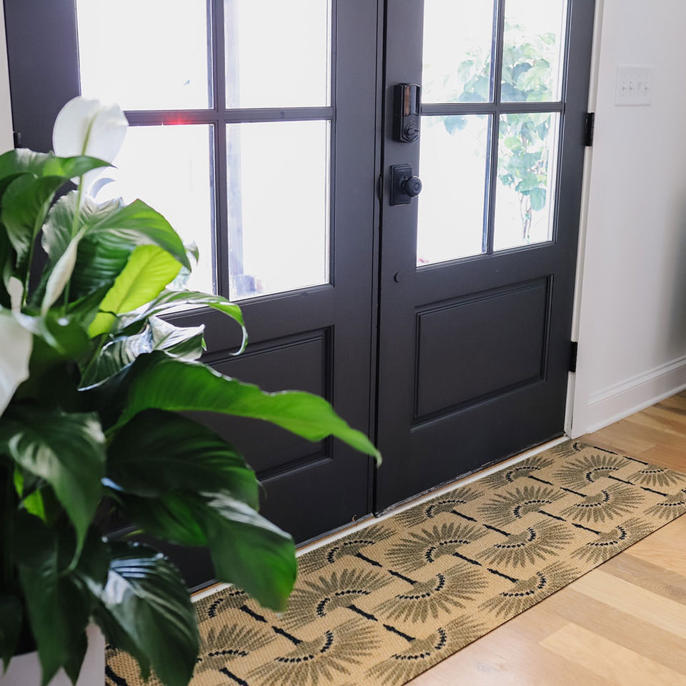 Tailfeathers double door mat in army and brown features a modern looking pattern that looks great in a hallway or in front of large double doors.