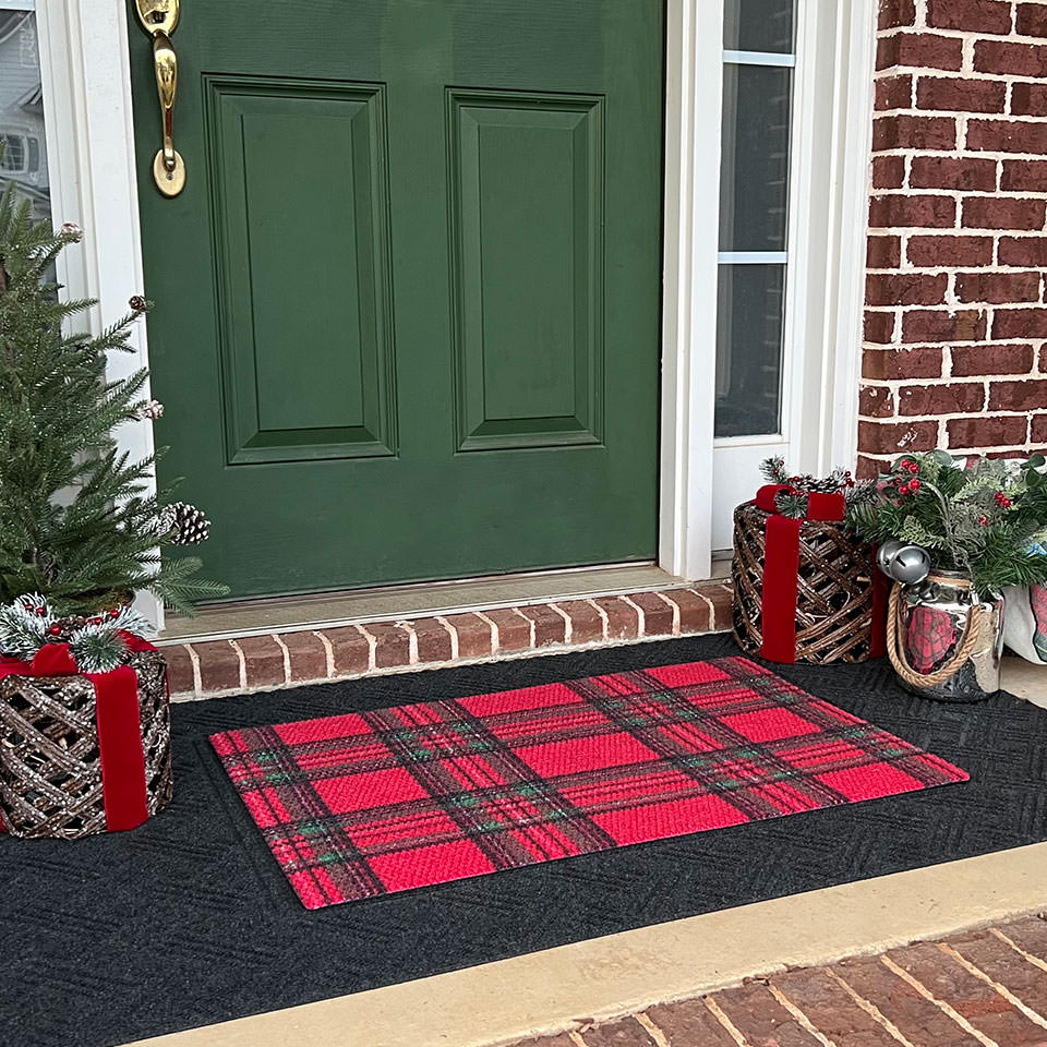 Low profile red tartan plaid doormat on top of low profile layered all weather doormat